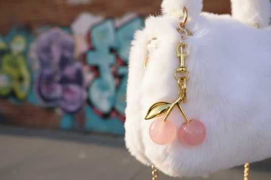 Cherry Bomb Charm on white fur bag