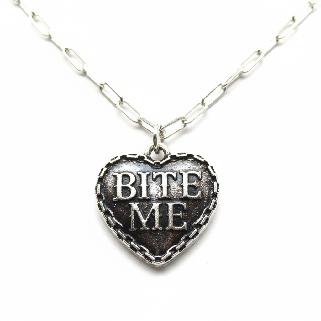 BITE ME Heart Necklace close-up detail showing engraving and chain border